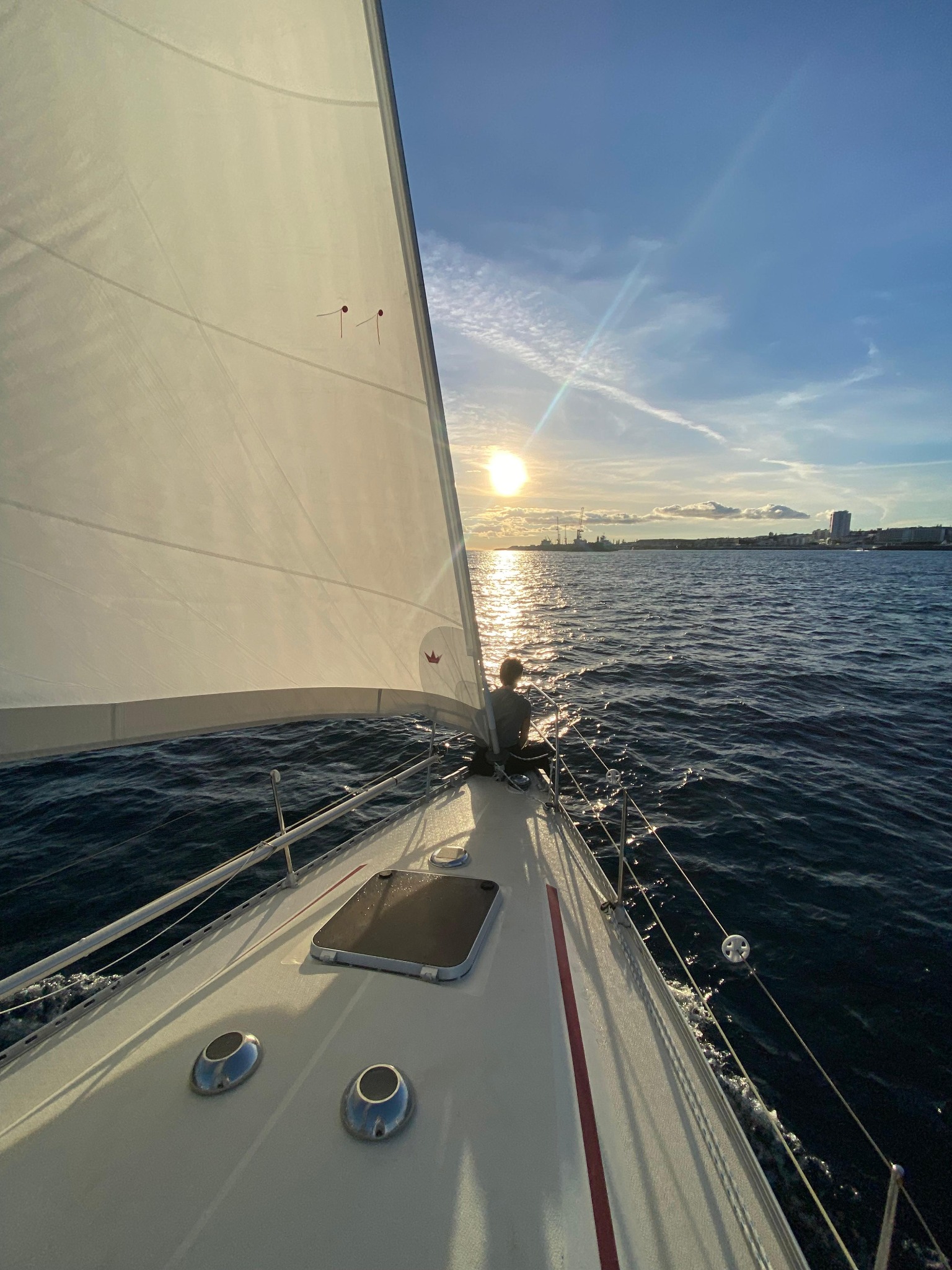 Sailing along the coast at sunset